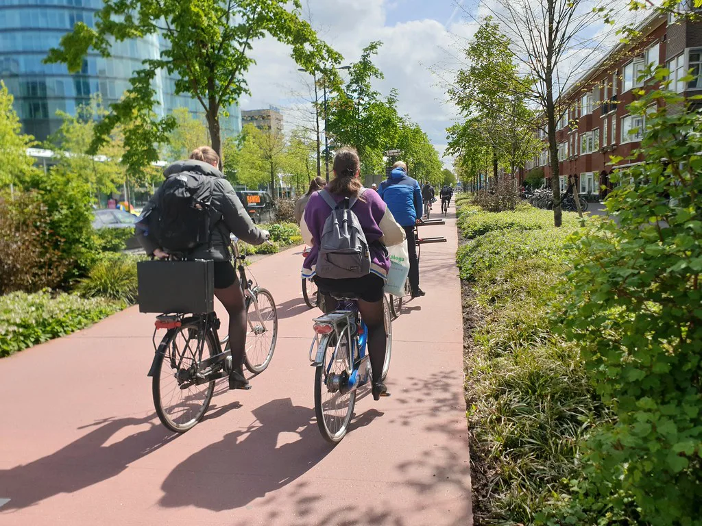 Cyclists on a red cycle path in Utrecht.