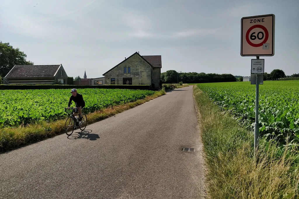 A cyclist on a country road on a Dutch cycle route.
