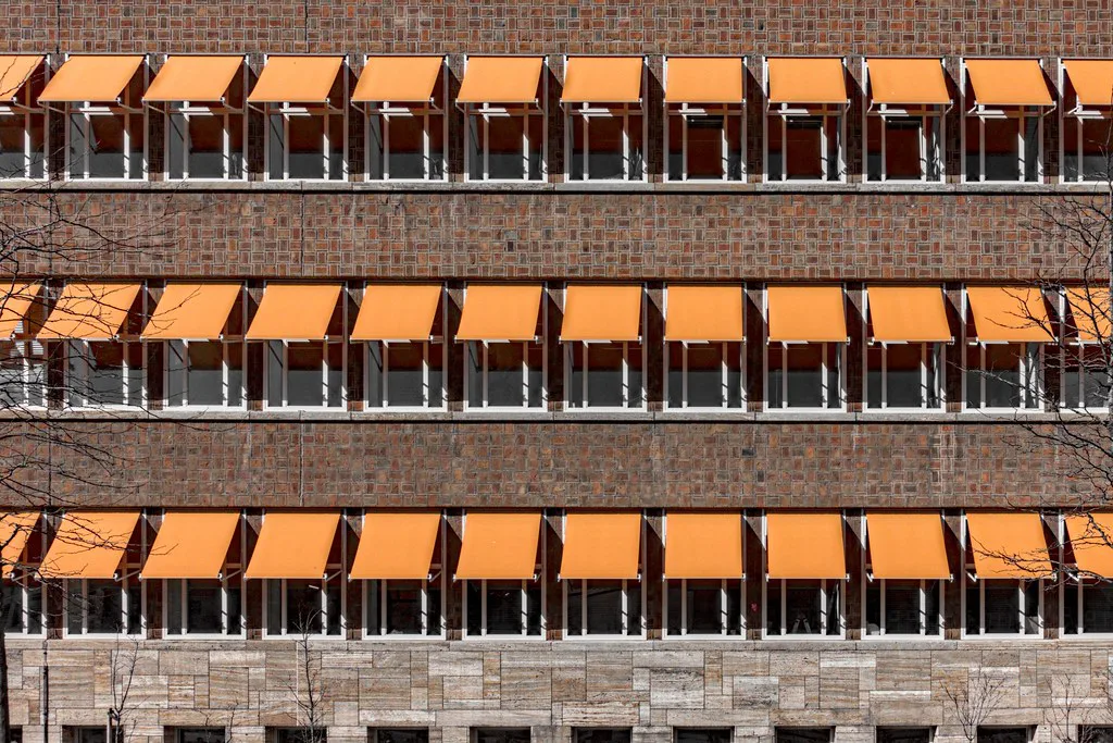 Orange awnings on a building in Rotterdam.